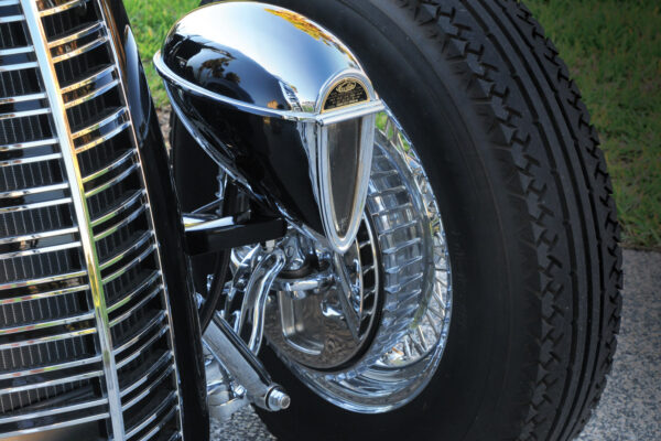 For a truly vintage style, the front suspension consists of a polished Pete & Jakes Hot Rod Parts drilled front axle with a transverse leaf spring, drop spindles, sea-leg (angled) shocks and hairpins.