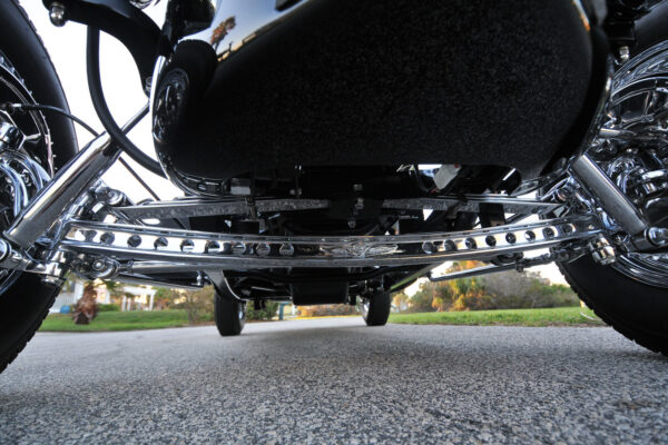For a truly vintage style, the front suspension consists of a polished Pete & Jakes Hot Rod Parts drilled front axle with a transverse leaf spring, drop spindles, sea-leg (angled) shocks and hairpins.