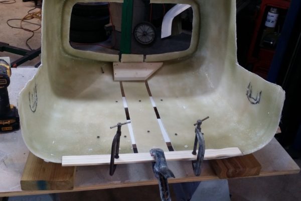 The fiberglass cowl was a standard width, but the frame was widened four inches. So the front cowl had to be sliced lengthwise and a four-inch strip glassed into it.