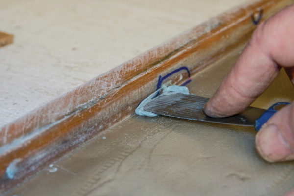 Once you’ve given it at least 24 hours to cure, inspect the mold for any rough areas or air bubbles that may have been trapped in the layup. If you find any, fill them with body filler with a spackling knife or apply more activated resin. Then fine-sand the inner surface smooth, and apply more gel coat.