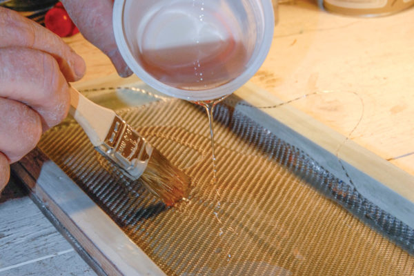 Back up your initial layer of Barracuda glass with six more layers, alternating between conventional fiberglass cloth and fiberglass mat. Place the mold under the heat lamps to cure the part.