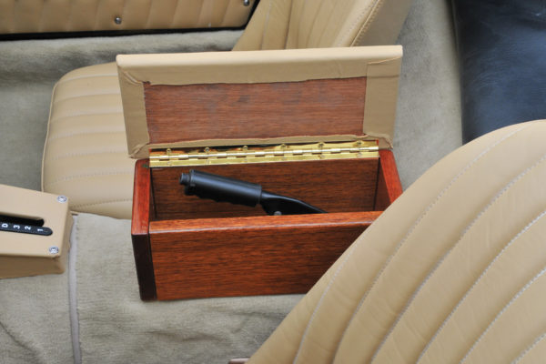 You might be surprised to find what’s under the lid of the box on the center console — the handbrake.