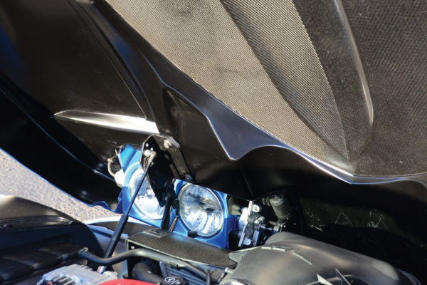 The special carbon fiber laminate, SPRINT CBS, is evident underneath the hood.