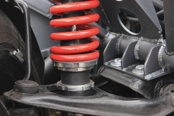 Here’s custom front suspension that starts with Miata parts, but mounts a quality double-adjustable coilover. The installation looks great, and it’s functional as well.