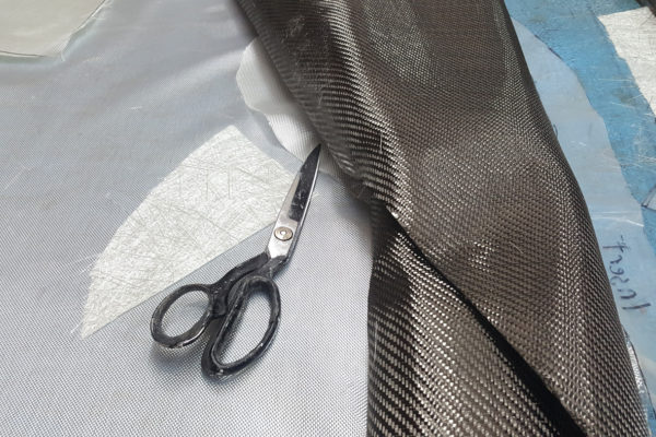 Carbon fiber cloth (right), while much more expensive than fiberglass, is much lighter and stronger. The dry, prepreg version is usually for professional lamination shops, while the wet layup can be handled by DIY car builders.