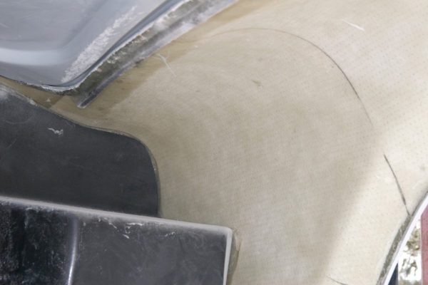 Coremat, a polyester non-woven material with small holes in it, is used in wheel wells to prevent or cut down on the possibility of star chips, caused by pebbles or small rocks thrown up against the underside of the fenders.