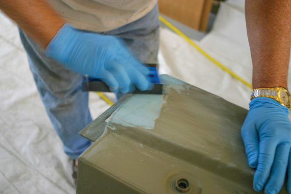 With 80-grit paper and the sanding block, you have to smooth out the filler to a point where the surfaces are as flat as they can be, which might require repeating this filler/sanding procedure several times. Then wipe the whole thing down with soapy water, and then clean the surface with Acryli-Clean in preparation for the urethane primer surfacer.