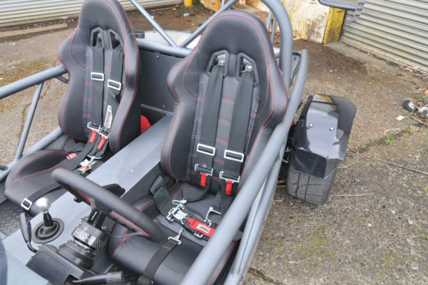  A good set of racing seats provides sturdy support for spirited driving, with the five-point racing harness keeping Del right where he belongs.