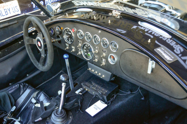 Note the MS3Pro ECU system mounted on the transmission tunnel below the dash. It’s readily accessible for all the laptop tuning required on the blown Coyote engine. The stick with the blue knob is the e-brake lever for initiating and controlling the drift action.