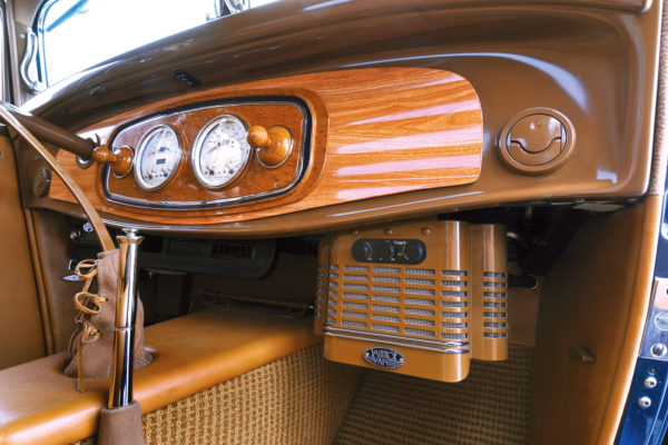 A custom Posies shroud conceals the modern Vintage Air HVAC system. Wood grain was expertly applied on the dash.