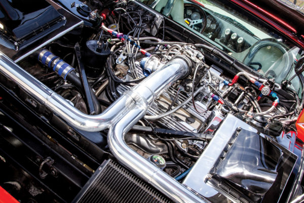 The engine bay is a maze of chromed and polished plumbing for the twin turbos. With forced induction, the Cadillac cranks out 500 horses.