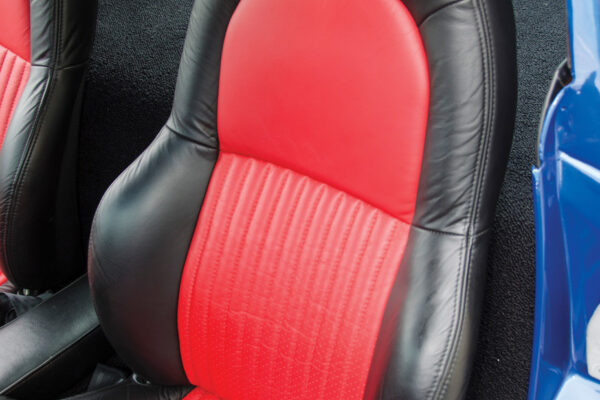 The seats are from a C5 Z06, and upholstered in black with red inserts and custom Grand Sport stitching.