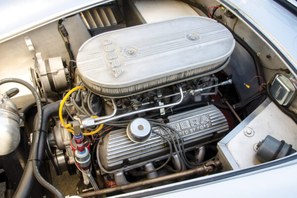 The 300 hp Ford 302 ci engine is slightly larger than the original 289 slab side’s, with dual 600 cfm Holley carbs.