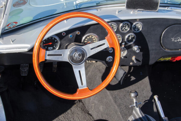 While the steering wheel is a traditional AC unit, the gauges are modern Autometer.