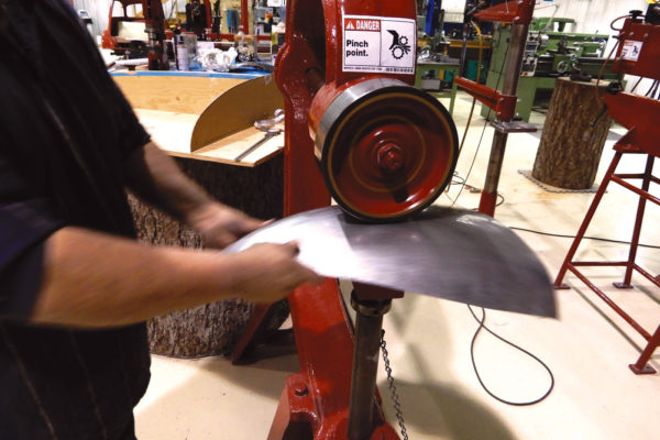Robert has spent thousands of hours on the traditional English wheel, and is using it here to subtly change the curve to fit the Bentley's tail panel buck.