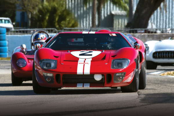 At the HSR Classic 12 Hours of Sebring, an Oltoff-built GT40 shows the way around the course to a couple of classic race cars.