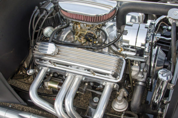 In such a lightweight rod, a Chevy 355 has plenty of grunt. It’s topped with an Edelbrock intake and carb. The Sprint-style headers are ceramic-coated for a long-lasting finish. 