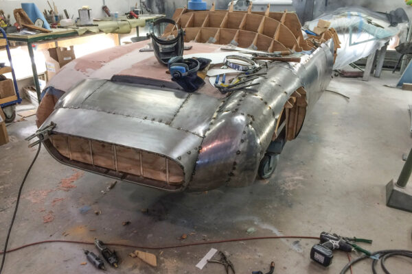 Scaled up from a 1/24- and then a 1/5-size model, the wooden station buck was skinned with sheet steel to serve as a solid plug for laying up a fiberglass body mold.   