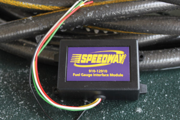 This is the Speedway fuel gauge interface module that allows any gas tank sender to work with any fuel gauge. Through a combination series of the DIP switches, you can match up any resistor output of the sender with any gauge and even adjust the included potentiometer (blue rectangle to the right of the switches) until the gauge needle aligns where you want it.