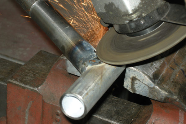 Remove any bumps where welds overlap using a 4 1/2-inch grinder.