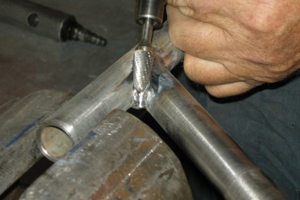 Shape the weld using a die grinder with a carbide burr.